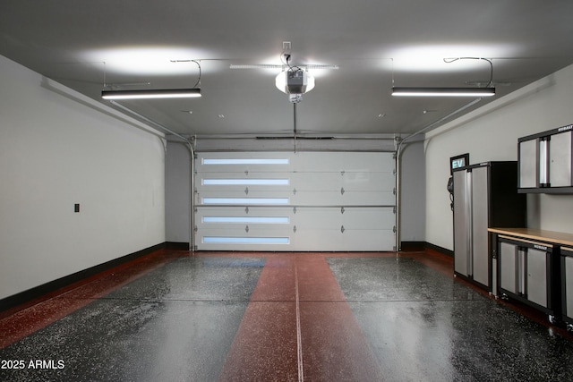 garage with baseboards and a garage door opener