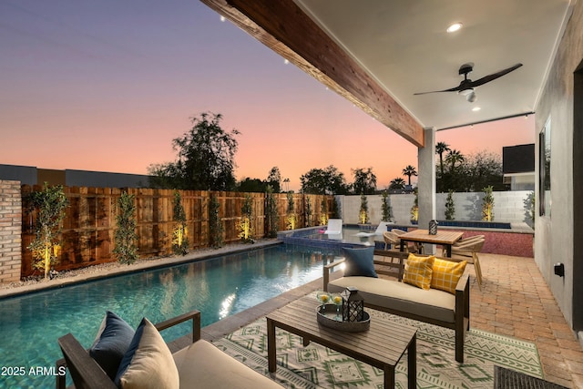 view of pool featuring ceiling fan, a fenced backyard, outdoor lounge area, a fenced in pool, and a patio area