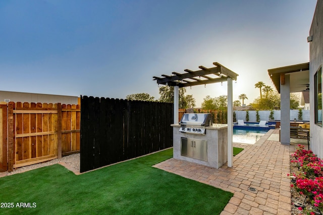 view of yard with exterior kitchen, a patio area, a fenced backyard, and a fenced in pool