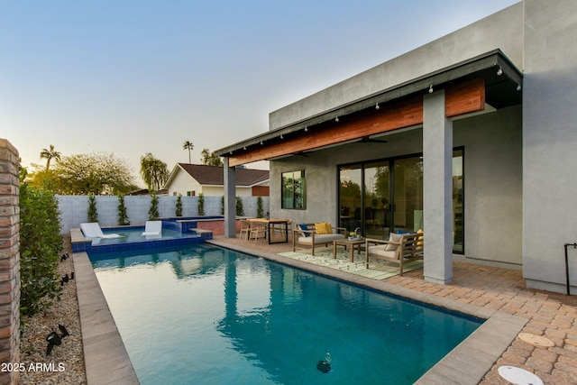 view of pool featuring a fenced in pool, a patio, a fenced backyard, an outdoor hangout area, and an in ground hot tub