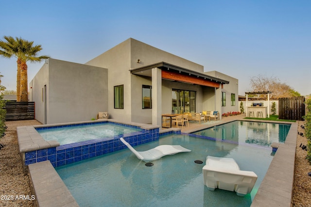 view of pool featuring a pool with connected hot tub, fence, outdoor lounge area, and a patio