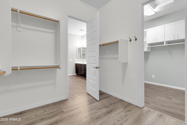 spacious closet featuring light wood finished floors