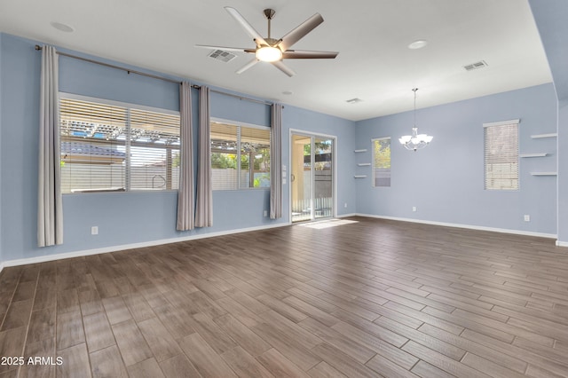 unfurnished room with wood-type flooring and ceiling fan with notable chandelier