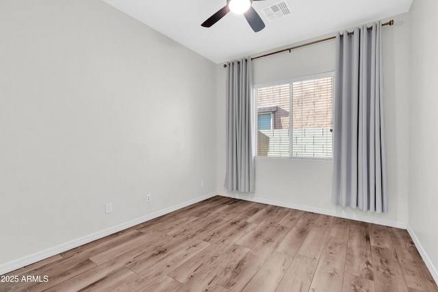 spare room with visible vents, baseboards, ceiling fan, and wood finished floors