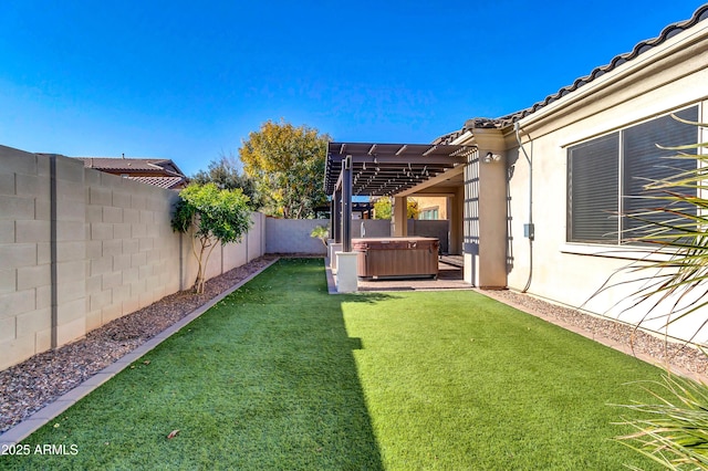 view of yard with a hot tub and a fenced backyard