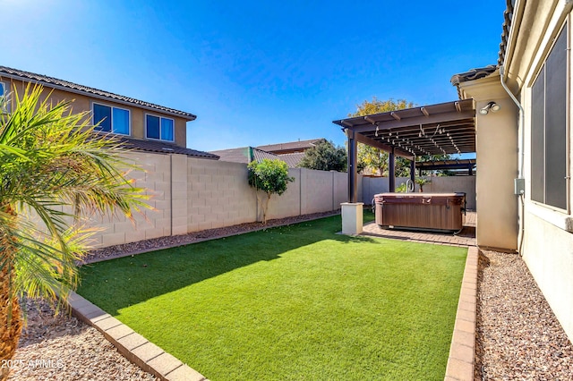 view of yard with a hot tub and a fenced backyard