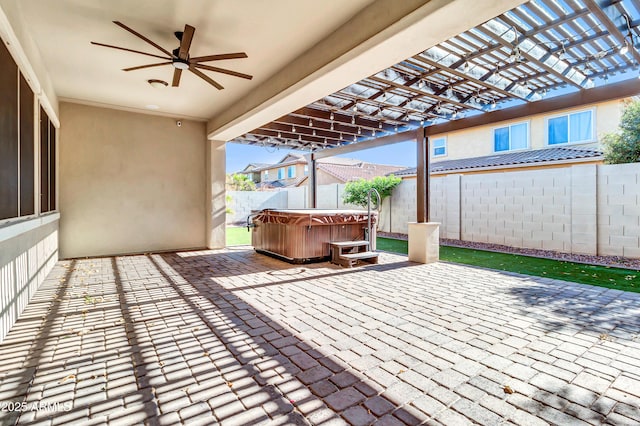 view of patio featuring a pergola, a hot tub, a ceiling fan, and fence