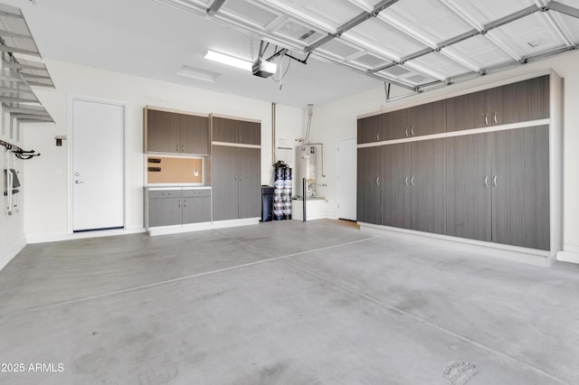 garage with gas water heater and a garage door opener