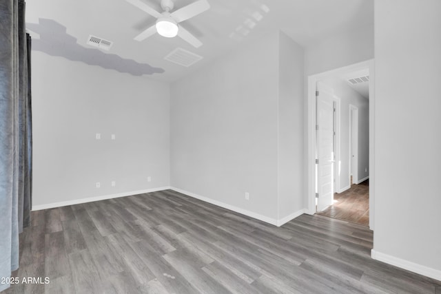 unfurnished room with visible vents, baseboards, wood finished floors, and a ceiling fan