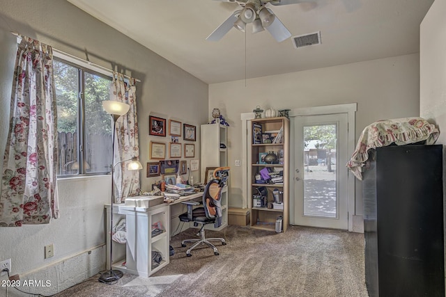 office area featuring plenty of natural light, light colored carpet, and ceiling fan