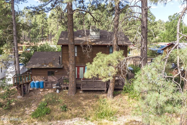 rear view of house featuring a wooden deck