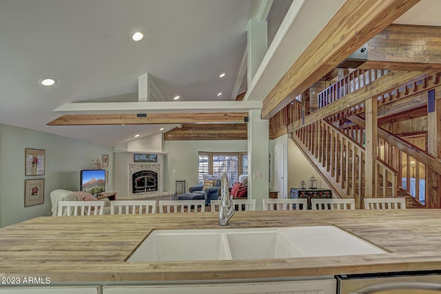 kitchen with lofted ceiling and a fireplace