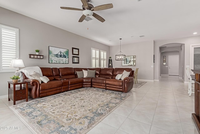 1036 W Siebold Tree Ave, Queen Creek, AZ 85140 - living room with arched walkways, a ceiling fan, recessed lighting, light tile patterned floors, and a chandelier