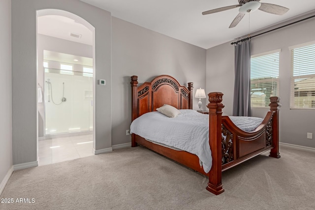 1036 W Siebold Tree Ave, Queen Creek, AZ 85140 - bedroom featuring carpet floors, baseboards, ensuite bath, a ceiling fan, and arched walkways