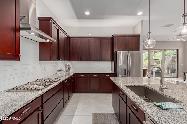 1036 W Siebold Tree Ave, Queen Creek, AZ 85140 - kitchen featuring stainless steel appliances, wall chimney range hood, a sink, backsplash, and pendant lighting