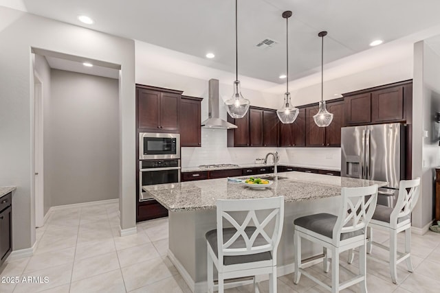 1036 W Siebold Tree Ave, Queen Creek, AZ 85140 - kitchen featuring stainless steel appliances, wall chimney exhaust hood, a sink, dark brown cabinets, and recessed lighting