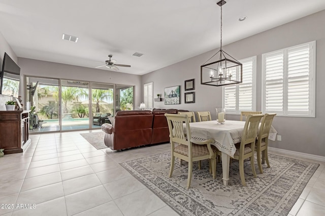 1036 W Siebold Tree Ave, Queen Creek, AZ 85140 - dining room featuring a chandelier, light tile patterned flooring, a ceiling fan, and baseboards