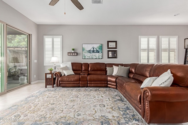 1036 W Siebold Tree Ave, Queen Creek, AZ 85140 - living room featuring ceiling fan, baseboards, and light tile patterned floors