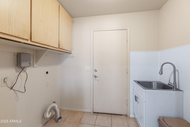 clothes washing area featuring cabinet space, a sink, hookup for an electric dryer, and light tile patterned floors