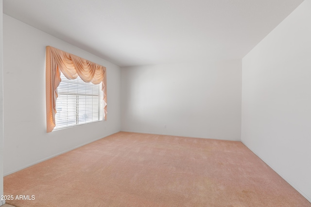 unfurnished room featuring light carpet