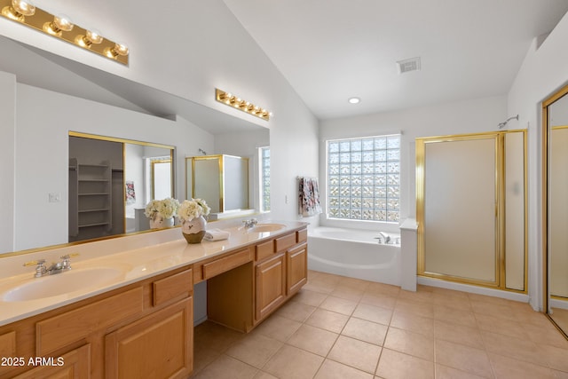 bathroom featuring vaulted ceiling, visible vents, a sink, and a garden tub