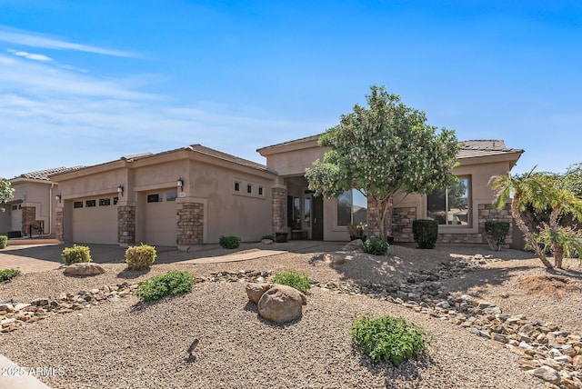 5813 E Ashler Hills Dr, Cave Creek, AZ 85331 - view of front of house featuring stone siding, an attached garage, driveway, and stucco siding