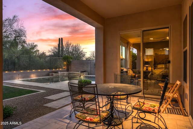 5813 E Ashler Hills Dr, Cave Creek, AZ 85331 - patio terrace at dusk with a fenced in pool and a fenced backyard
