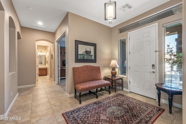 5813 E Ashler Hills Dr, Cave Creek, AZ 85331 - entryway with plenty of natural light, arched walkways, visible vents, and baseboards