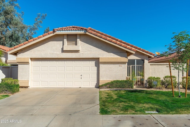 view of front of property with an attached garage, a tile roof, and stucco siding