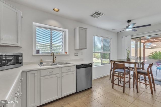 kitchen featuring a sink, visible vents, appliances with stainless steel finishes, and light countertops