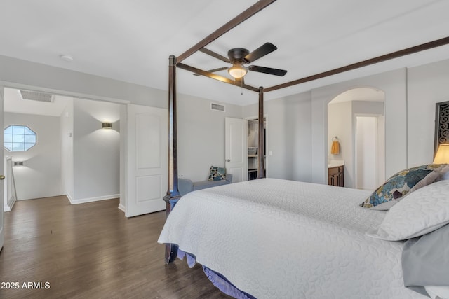 bedroom with arched walkways, visible vents, ceiling fan, and dark wood-style flooring