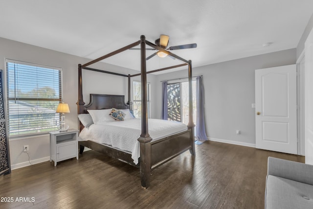 bedroom with baseboards, multiple windows, and wood finished floors