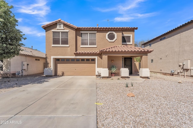 mediterranean / spanish-style house with stucco siding, a garage, driveway, and a tile roof