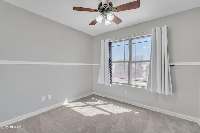 spare room featuring carpet flooring, baseboards, and ceiling fan