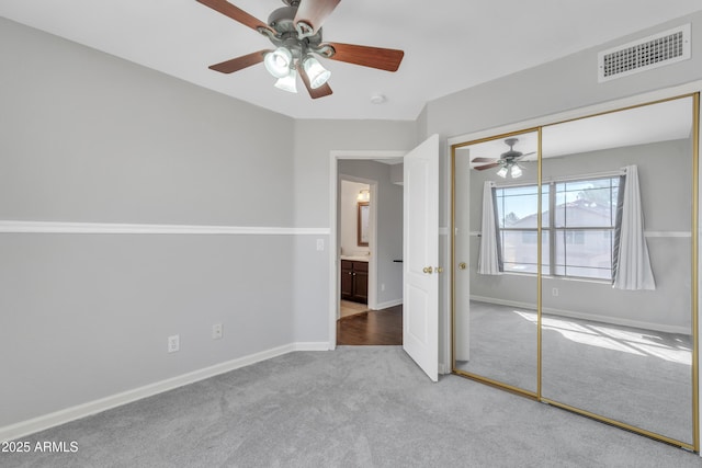 unfurnished bedroom with a ceiling fan, baseboards, visible vents, a closet, and carpet flooring