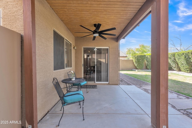 view of patio with a ceiling fan and fence