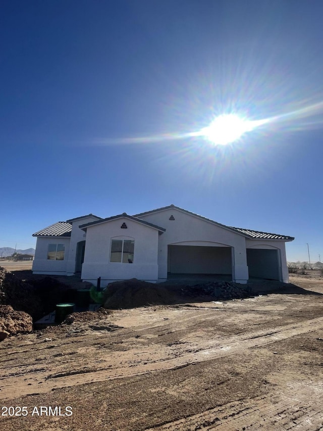 view of front of house featuring a garage and stucco siding