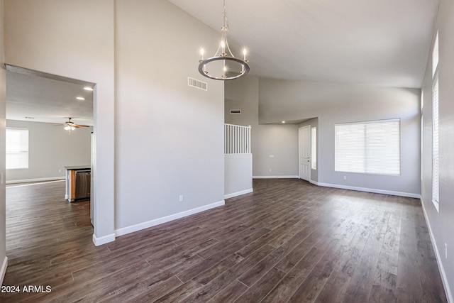 interior space featuring ceiling fan with notable chandelier, dark hardwood / wood-style flooring, and high vaulted ceiling