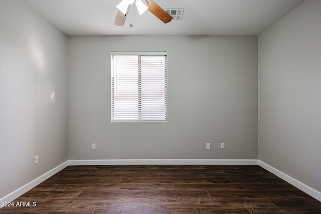 spare room with ceiling fan and dark wood-type flooring