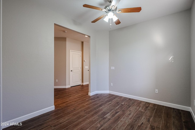 spare room with dark hardwood / wood-style floors and ceiling fan