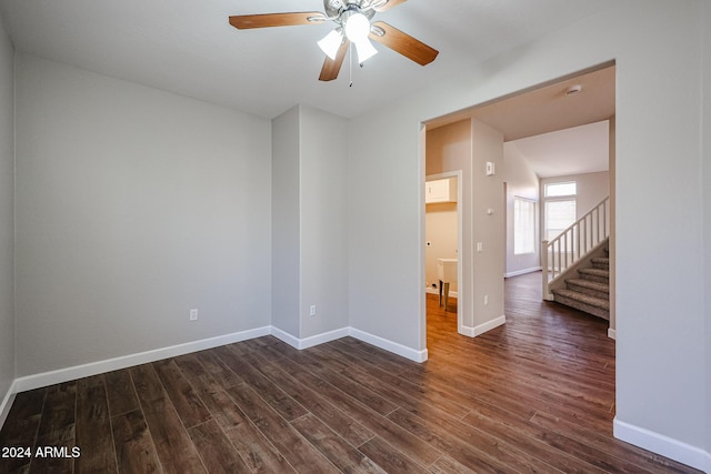 unfurnished room featuring ceiling fan and dark wood-type flooring