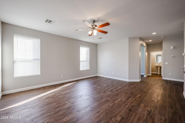 spare room with ceiling fan and dark hardwood / wood-style flooring