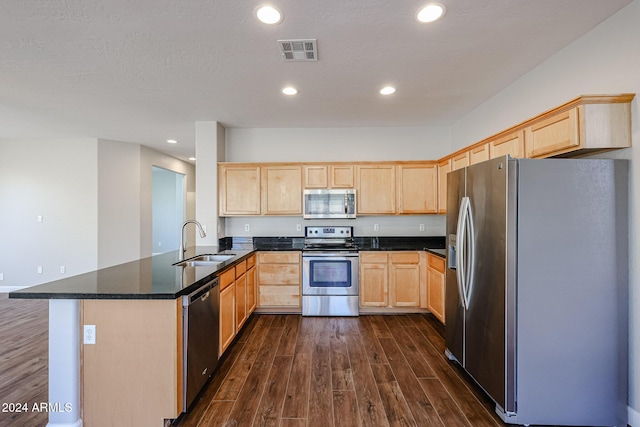 kitchen featuring dark wood-type flooring, sink, light brown cabinetry, appliances with stainless steel finishes, and kitchen peninsula