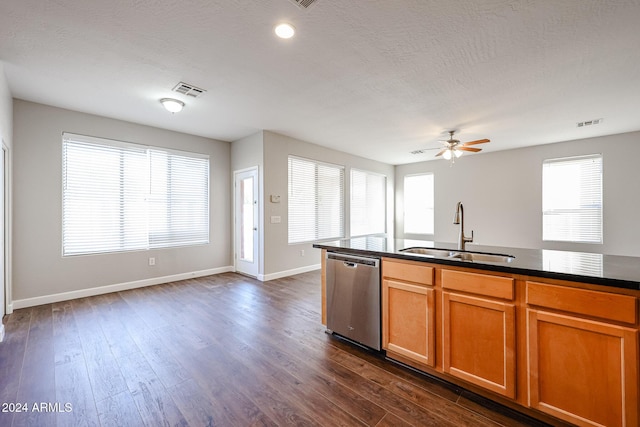 kitchen with a textured ceiling, ceiling fan, dark wood-type flooring, sink, and dishwasher