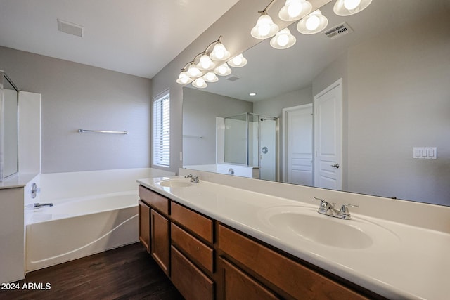 bathroom featuring vanity, hardwood / wood-style flooring, and separate shower and tub