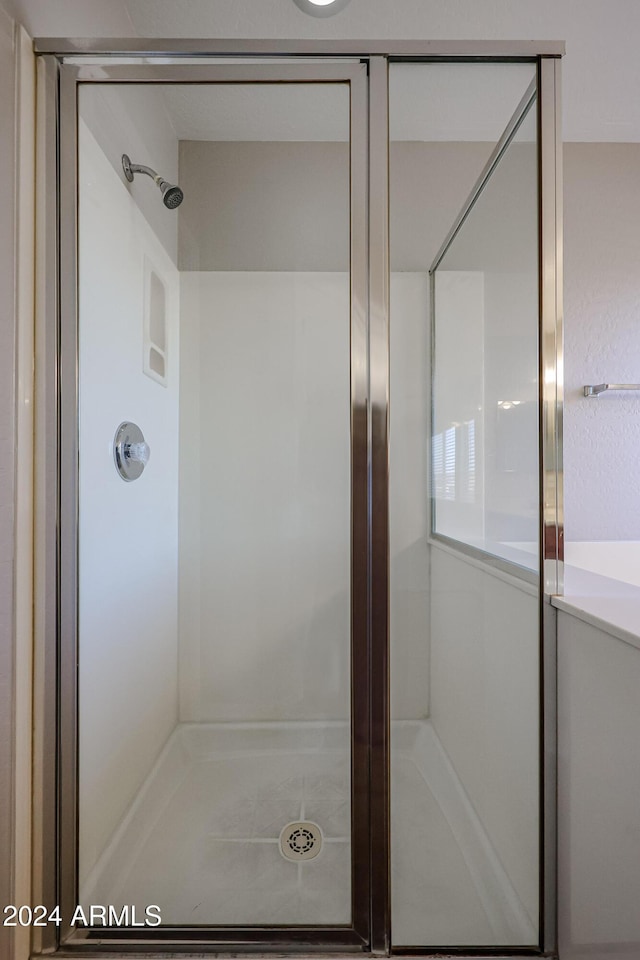 bathroom with a shower with shower door