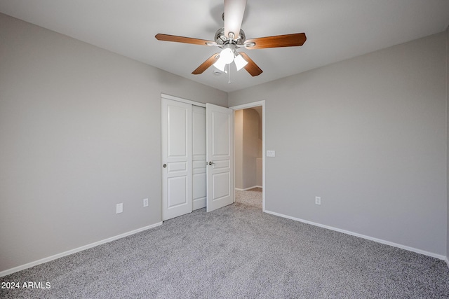 unfurnished bedroom with ceiling fan, a closet, and carpet floors