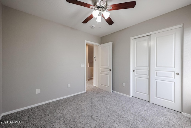 unfurnished bedroom with carpet flooring, ceiling fan, and a closet