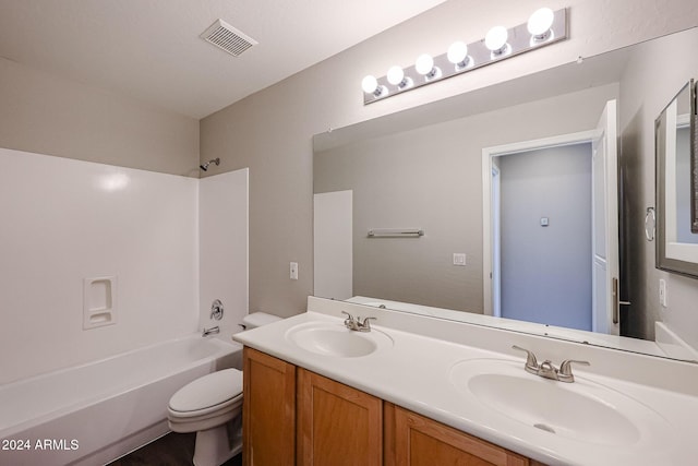 full bathroom featuring vanity, bathtub / shower combination, and toilet