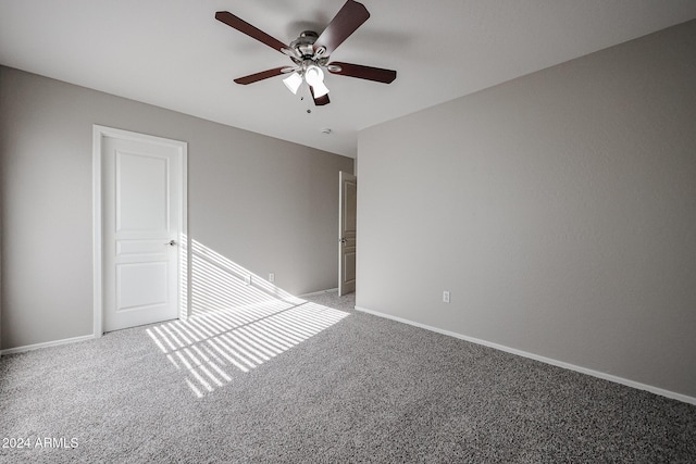 unfurnished room featuring carpet and ceiling fan